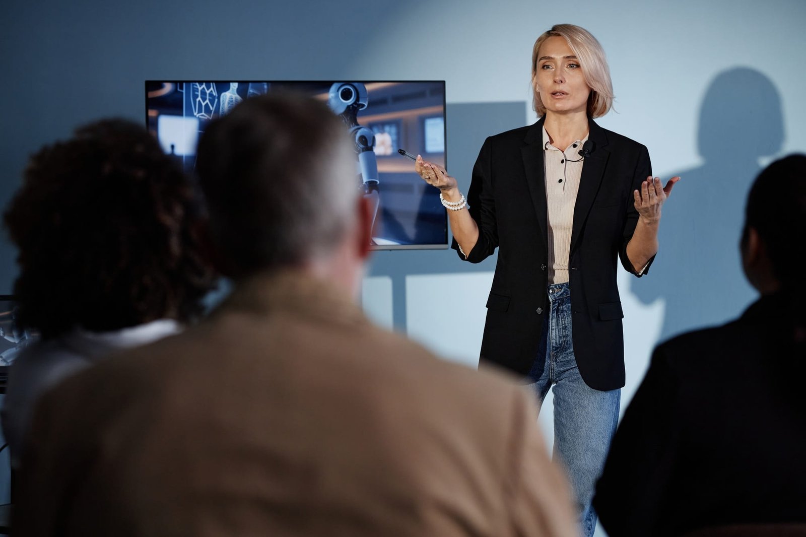 Female Speaker Presenting at Business Meeting in Auditorium